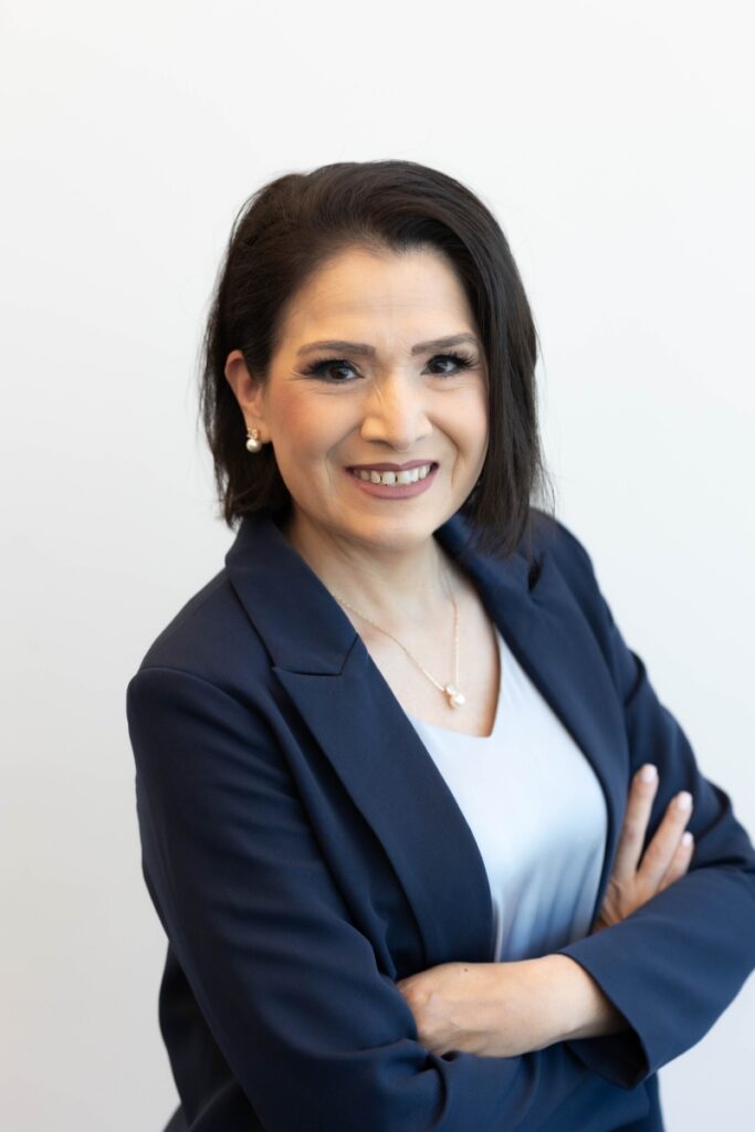 Monica Weaver, Education Program Coordinator at an Oklahoma City adult learning center, smiling confidently in a navy blazer.